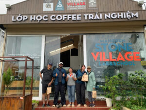 Đoàn khách chụp ảnh lưu niệm trước Stone Village Lab Măng Đen sau tour trải nghiệm cà phê