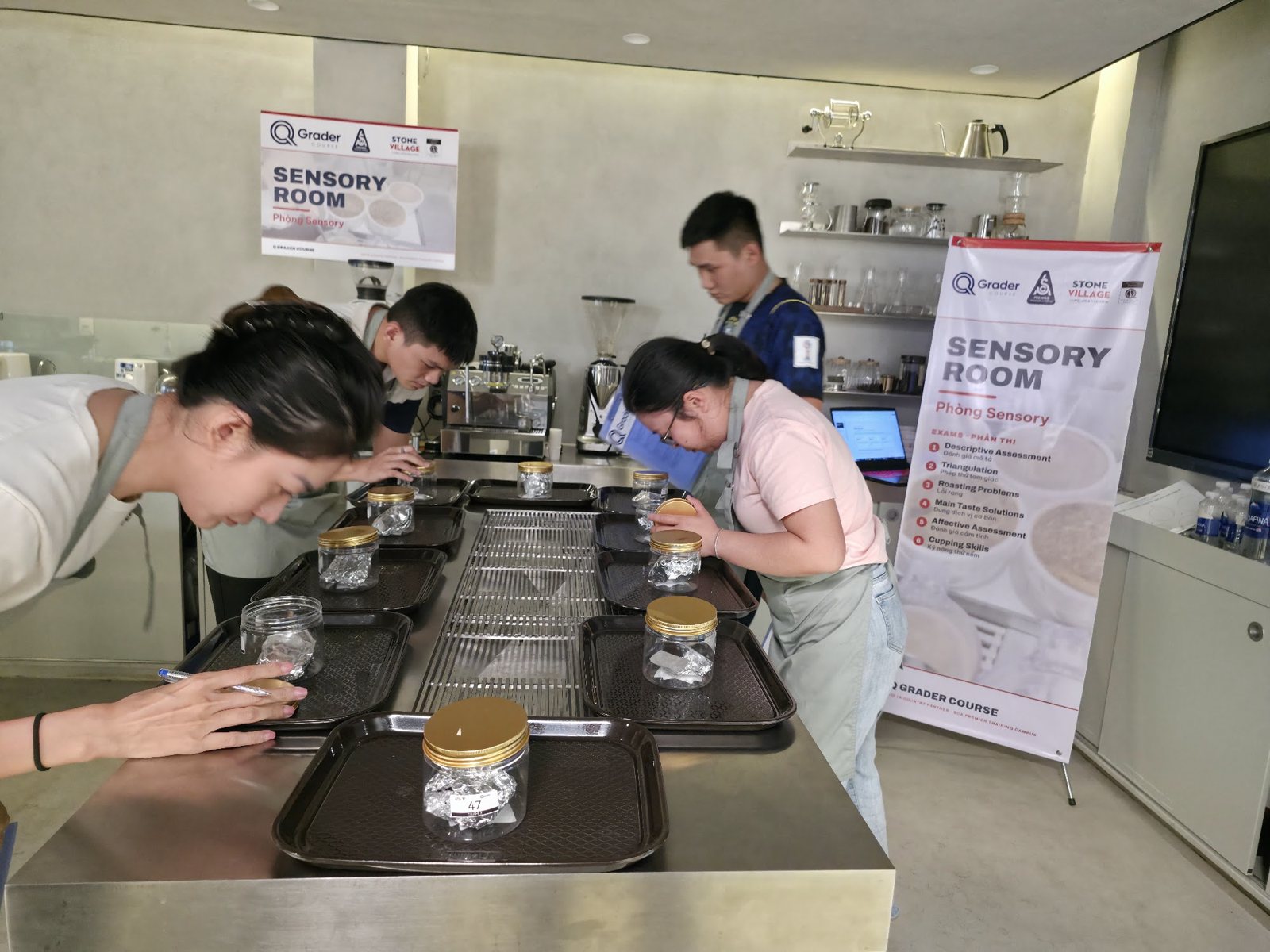 Học viên cúi sát hũ mẫu cảm nhận hương trong bài thi nhóm mùi